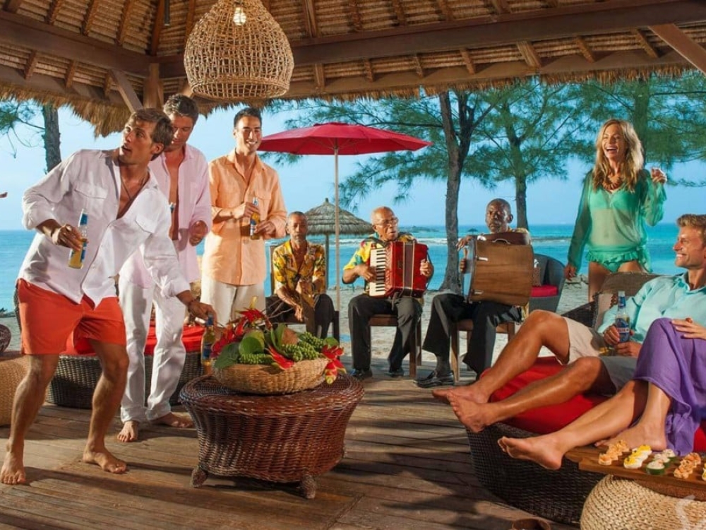 A group of friends on the offshore island at Sandals Royal Bahamian