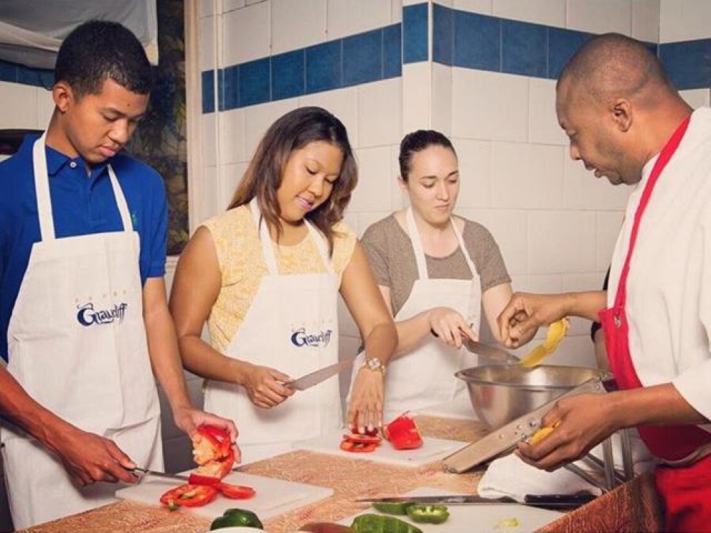 People attending a chef-guided food class.